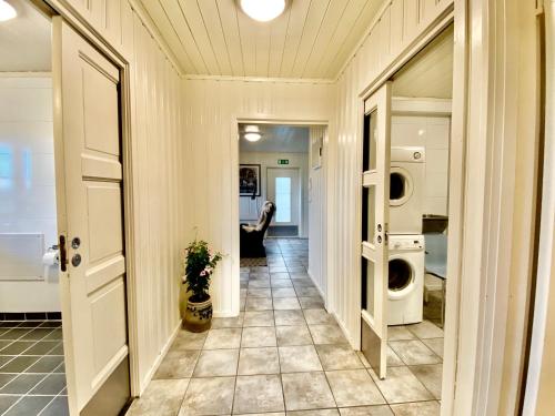 a hallway with a washer and dryer in a house at Sarpsborg Apartments - Utne Camping in Solli