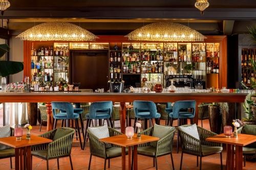 a bar in a restaurant with tables and chairs at Giardino Ascona in Ascona