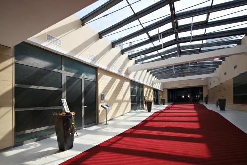 a hallway with a red carpet in a building at Radenci Spa Resort - Sava Hotels & Resorts in Radenci