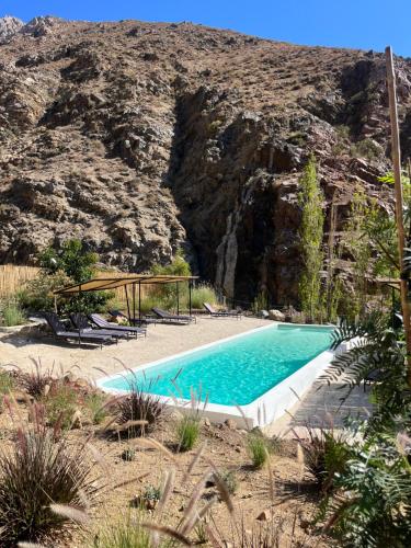 a swimming pool in the middle of a mountain at Glaciar de Roca Lofts in Horcon