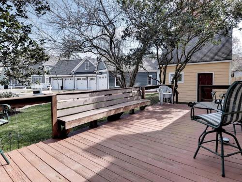 a wooden deck with a bench and a table at Aldrich House Bed & Breakfast in Williamsburg