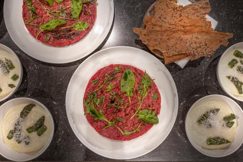 a group of four plates of food on a table at LUGANODANTE Boutique & Lifestyle Hotel in Lugano