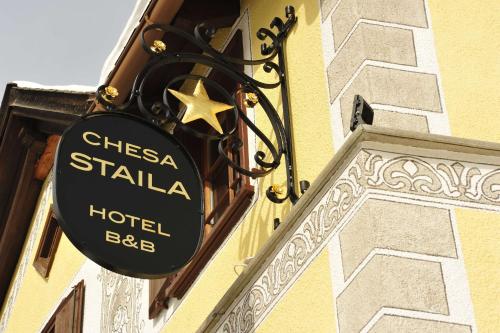 a hotel sign on the side of a building at Hotel Chesa Staila in La Punt-Chamues-ch