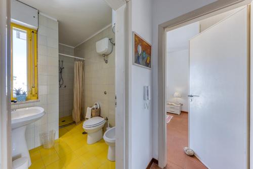 a bathroom with a toilet and a sink and a shower at Bouganville in Leuca
