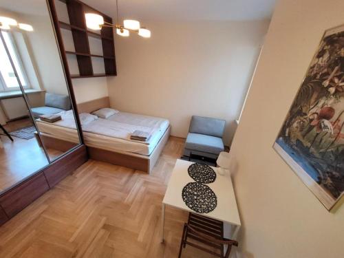 a small room with a bed and a mirror at Your Apart Powiśle Fabryczna Warszawa in Warsaw