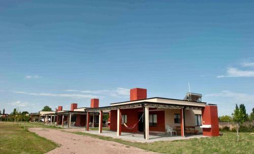 a building with red chimneys on it in a field at Cabañas Morita Mia in San Rafael