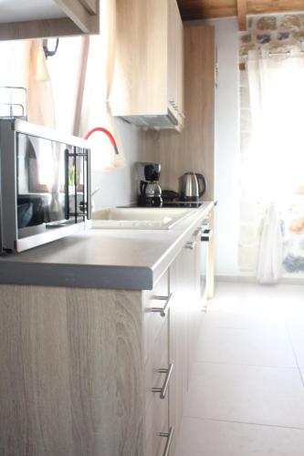 a kitchen with white cabinets and a counter top at Piedra Residence in Pigi