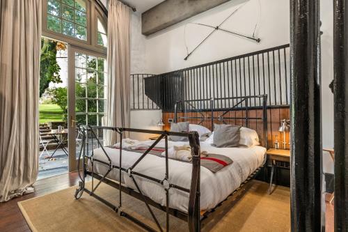 a bedroom with a wrought iron bed and a desk at Slebech Park Estate in Wiston