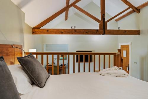 a bedroom with a bed with white sheets and pillows at Slebech Park Estate in Wiston