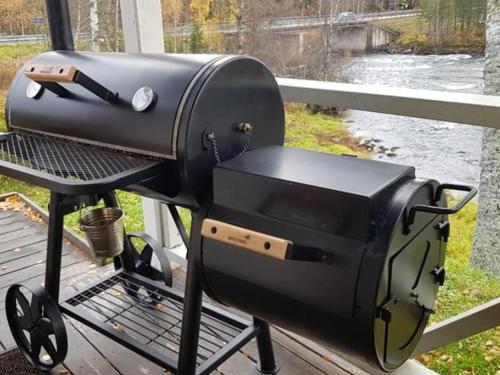 a grill sitting on a table next to a river at Överammers Cabins in Stugun