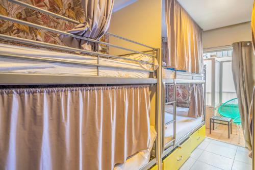 a room with two bunk beds with a window at Casa Barcelo Camp Nou Barcelona in Hospitalet de Llobregat