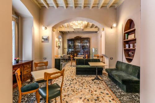 a living room with a couch and a table and chairs at Hotel Santa Marta Suites in Milan