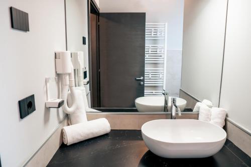 a bathroom with a toilet and a sink and a mirror at K MODERN HOTEL in Peschiera del Garda