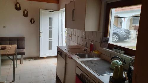 a kitchen with a sink and a car outside a window at Jäger-Lodge in Lócs