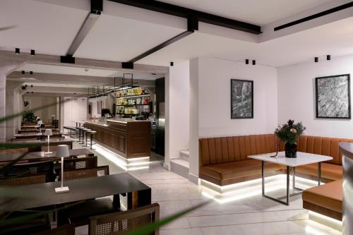 a restaurant with tables and chairs and a counter at InnAthens in Athens