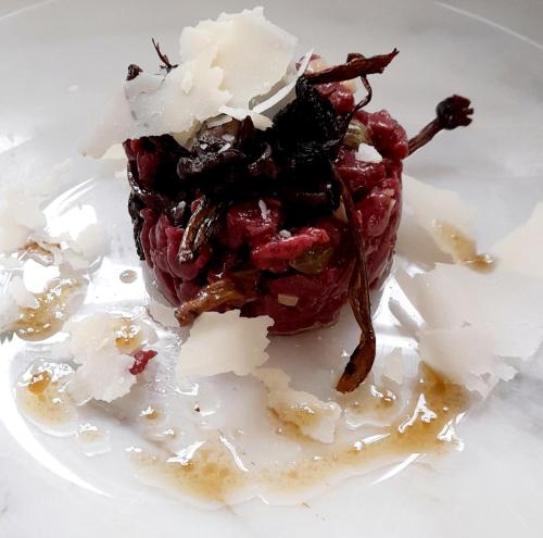 a pomegranate dessert on a white plate at La Ferme du Soyeuru in Spa
