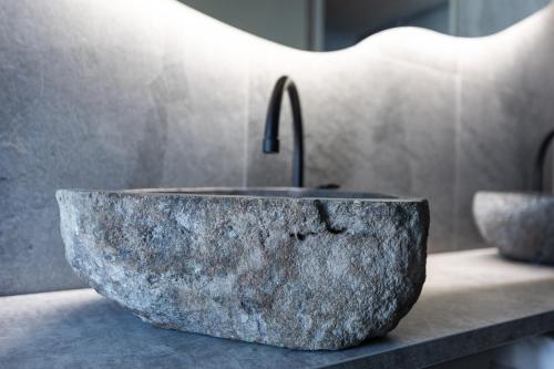 a stone sink with a faucet on a counter at Santa's Hotel Rakka in Kilpisjärvi