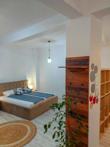 a bedroom with a bed with a blue comforter at InTown in Constanţa