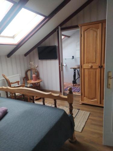 a bedroom with a bed and a table and a mirror at Magyar Lovasvendégház in Szilvásvárad