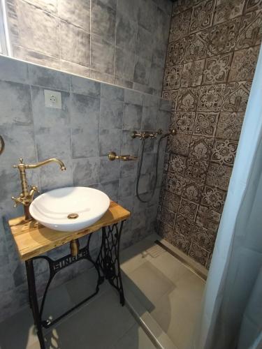 a bathroom with a sink and a shower at Magyar Lovasvendégház in Szilvásvárad