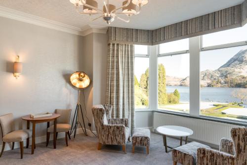 a room with a large window with chairs and a table at The Inn On The Lake in Glenridding