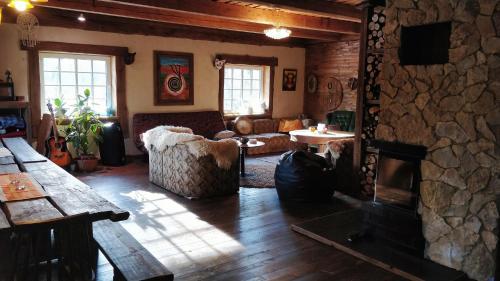 a living room with a fireplace and a stone wall at Uneallika peamaja in Pae