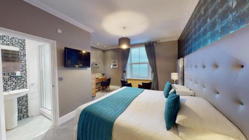Ein Bett oder Betten in einem Zimmer der Unterkunft Tynedale Hotel