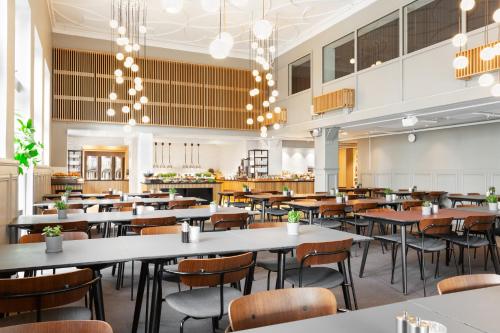an empty restaurant with tables and chairs at Quality Hotel Augustin in Trondheim