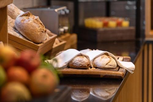 a bakery with loaves of bread on a shelf at Quality Hotel Augustin in Trondheim