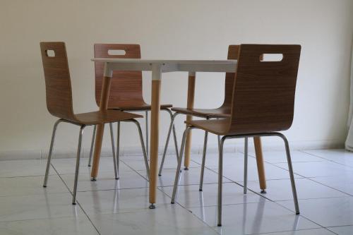 three chairs and a table and a table and chairs at Sakhra hostel in Dubai