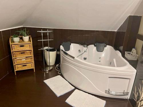a large white bath tub in a bathroom at Dom na wzgórzu - Brenna in Brenna