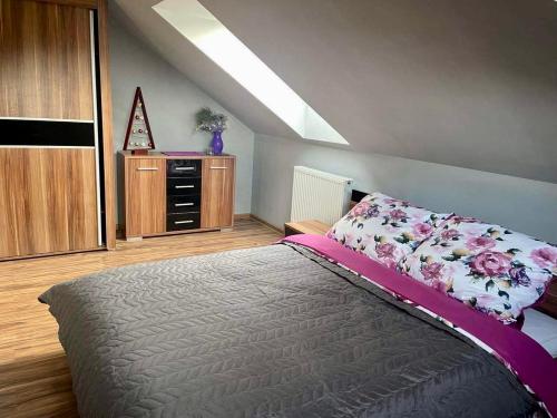 a bedroom with a bed and a dresser at Dom na wzgórzu - Brenna in Brenna