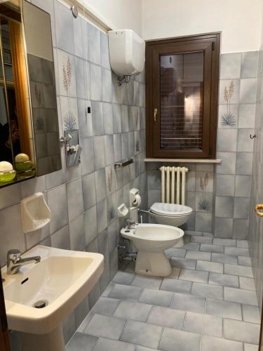 a bathroom with a white toilet and a sink at Le Coccole Del Trasimeno in Tuoro sul Trasimeno