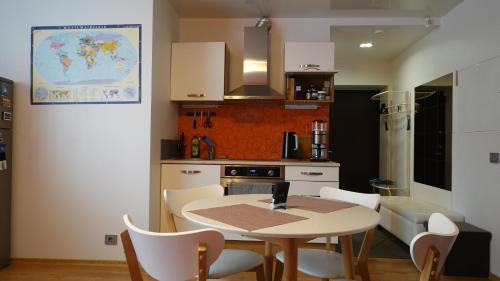 a kitchen with a table and chairs in a room at Cozy Telliskivi apartment near city centre in Tallinn