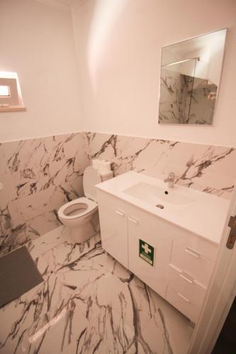 a bathroom with a sink and a toilet and a mirror at Oriente DNA Studios II in Lisbon