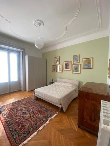 a bedroom with a bed and a rug at Gambara Apartment in Milan