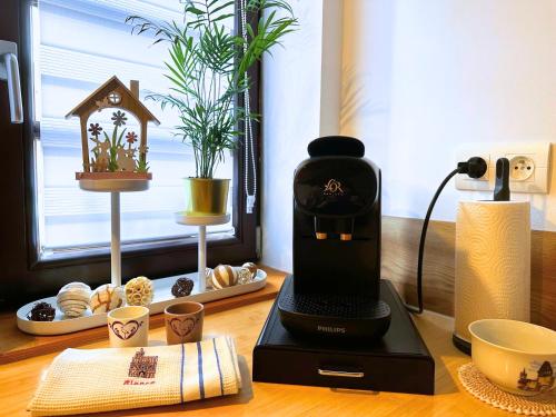 a coffee maker sitting on top of a table at Le petit Châtaignier - Cozy Immo in Châtenois