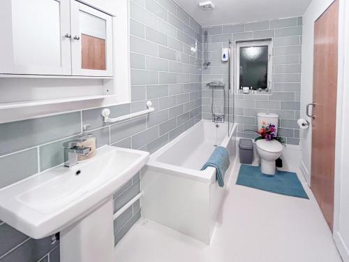 a white bathroom with a sink and a toilet at River Bay in Cardiff