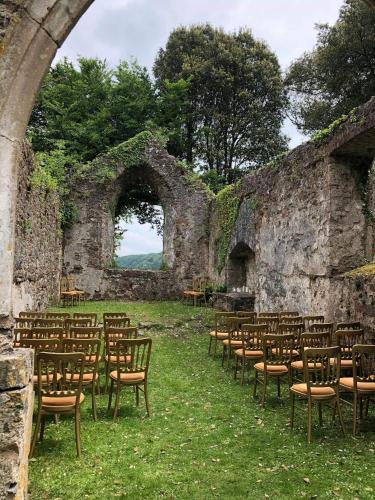 a group of chairs and tables in a stone wall at Slebech Park Estate in Wiston