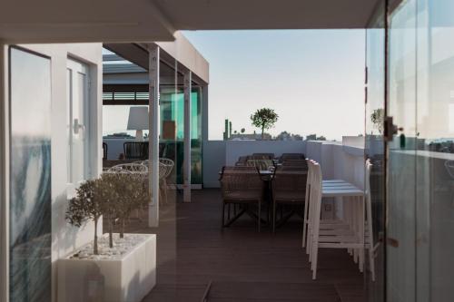 a balcony with a table and chairs on a building at Acropolis Select in Athens