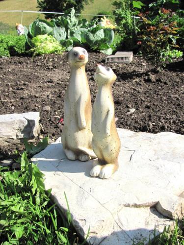 two statues of two penguins sitting on a rock at Libiseller Anita Unterhub in Taxenbach