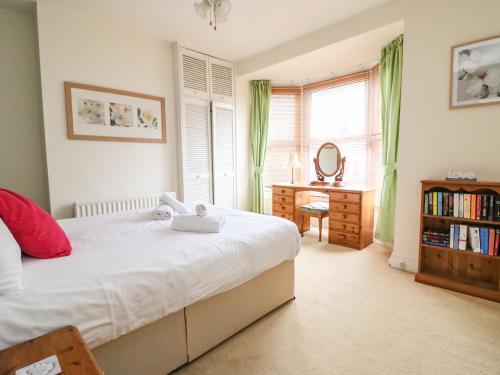 a bedroom with a bed and a desk with a mirror at Brewers House in Weymouth