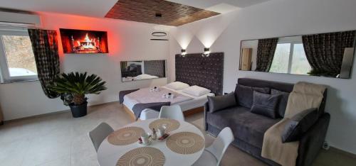 a living room with a couch and a table at Resort TimAJA - pool, massage pool, sauna in Trebnje