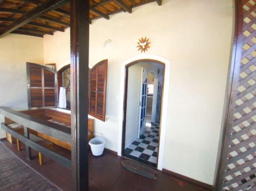 einen Flur eines Hauses mit einem Spiegel an der Wand in der Unterkunft Condomínio encantador com piscina em Itaúna in Saquarema