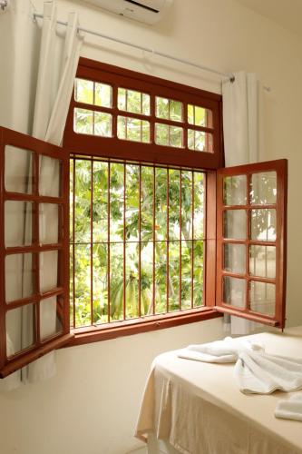 a bedroom with an open window and a bed at Pousada Convento da Conceição in Olinda