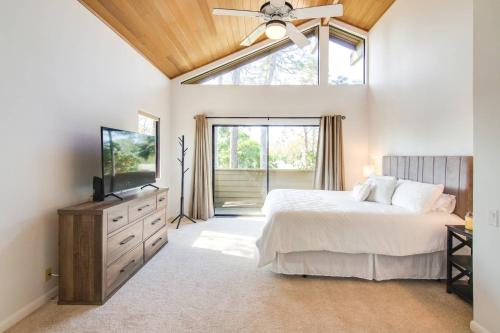 a bedroom with a bed and a tv and a window at Canopy on Cobblestone in Wesley Chapel