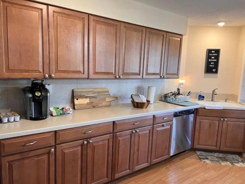 a kitchen with wooden cabinets and a counter top at Super Comfy " Arcade" Home in Cape Coral, Great Location! in Cape Coral