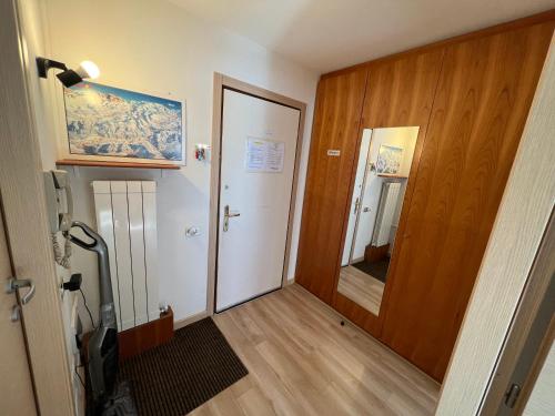 a room with a hallway with a door and a mirror at Appartamento vacanza Top Residence in Passo del Tonale