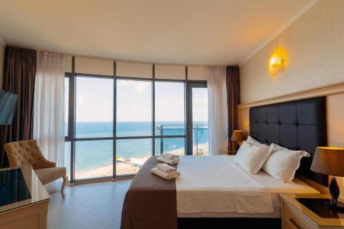a hotel room with a bed and a large window at Hotel 19 Batumi in Batumi