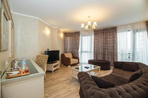 a living room with a couch and a tv at Hotel 19 Batumi in Batumi